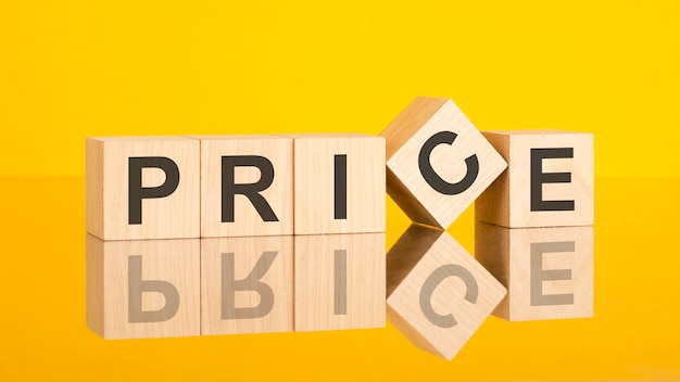 Price text written on wooden cubes yellow background concept