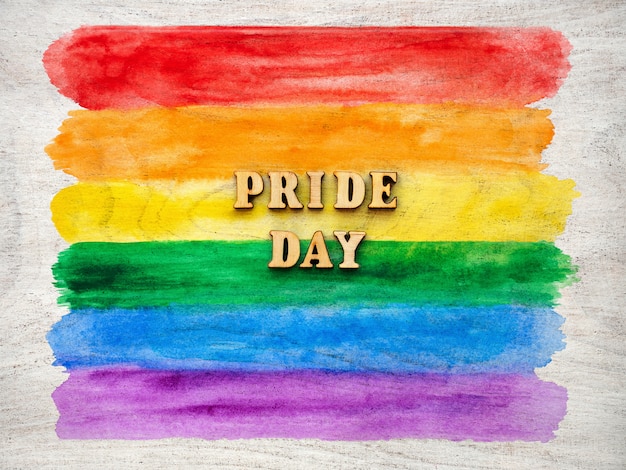 Pride day text with rainbow hearts