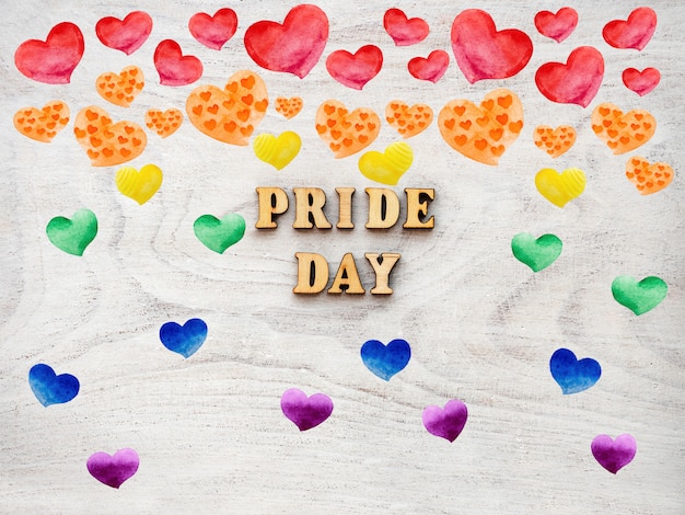 Pride day text with rainbow hearts