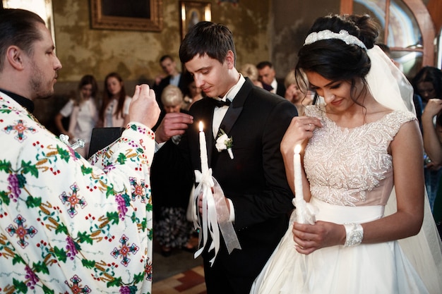 Priest blesses wedding couple in the church