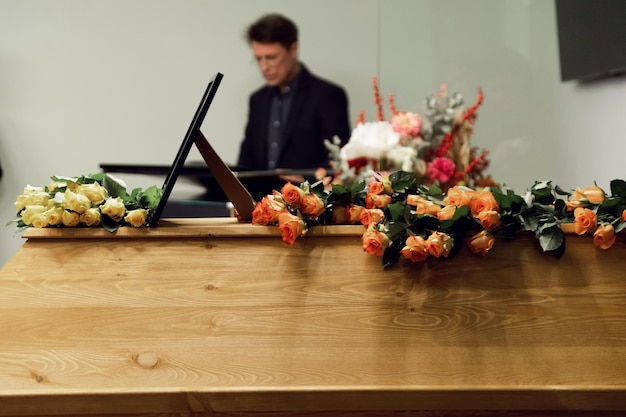 the priest conducts the funeral service hard times funeral service coffin with flowers