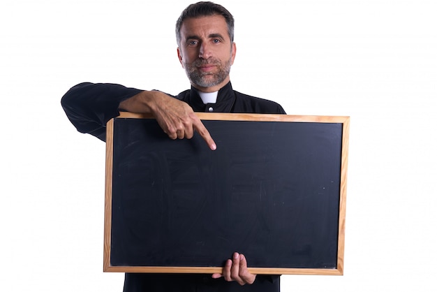 Priest holding empty blackboard copy space