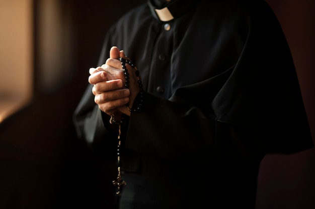 Priest praying in church