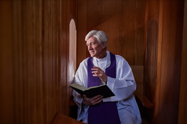 Priest talking to sinner during confession