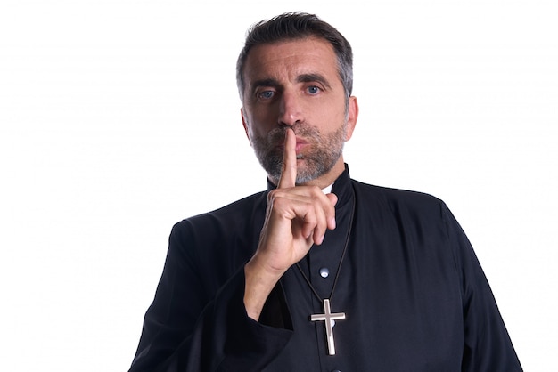 Priest with finger in lips as a silence