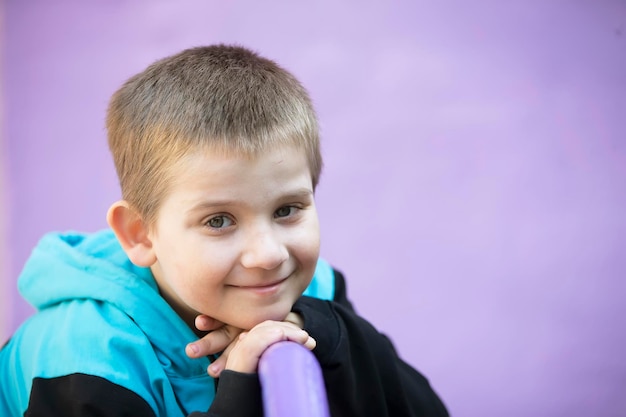 Primary school student Preschooler Child on a purple background Little blond boy smiles