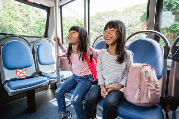 Primary student going to school by bus public transportation together