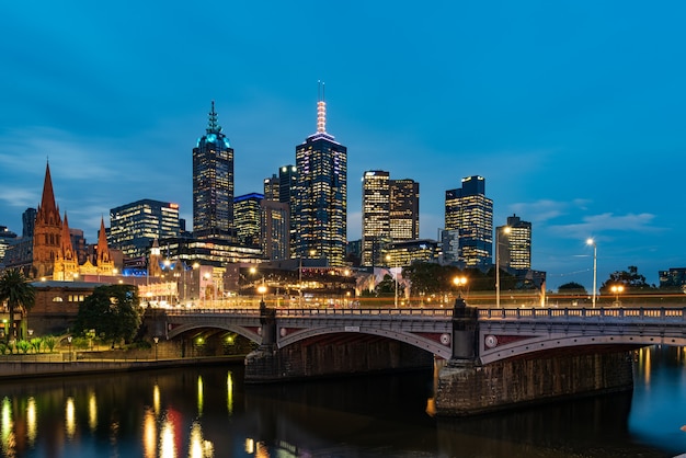 Princes Bridge and city buildings on the Yarra River in Melbourne, Australia in the evening