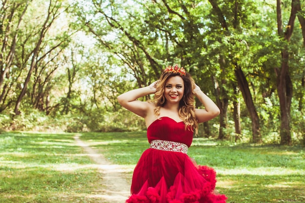 Princess with crown in cloudy red dress