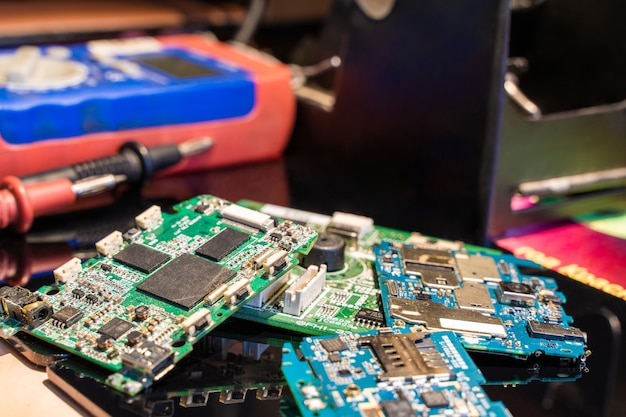 Printed Circuit Board with Other Equipment on Black Table Engineer Workplace Stock Photo