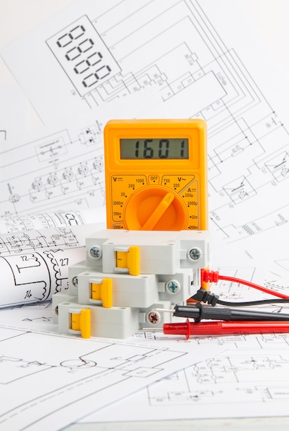 Printed drawings of electrical circuits, digital multimeter and electrical circuit breaker