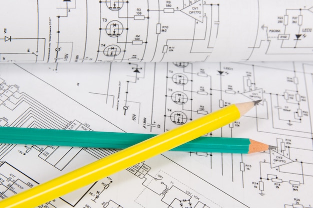 Printed drawings of electrical circuits and pencils. 