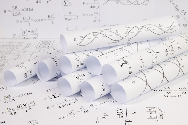 Printed on paper mathematical electrical formulas, graphs and engineering drawings