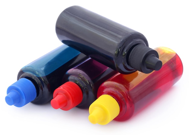 Printer ink bottles over white background