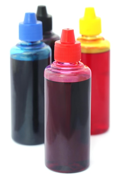 Printer ink bottles over white background