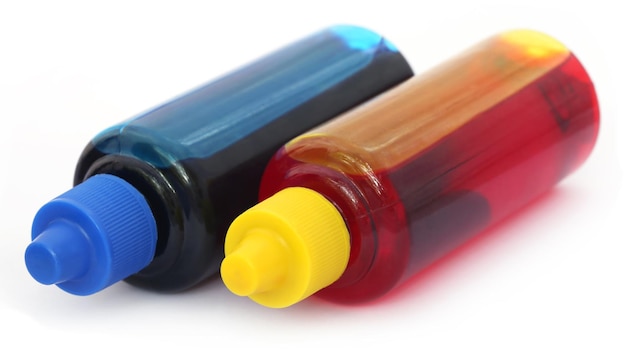 Printer ink bottles over white background