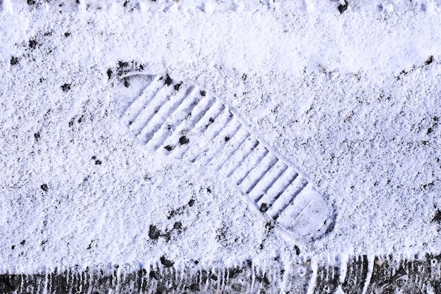 Prints on snow ground on the first snowy day of winterTraces of a bird in the snow in closeup Winter background