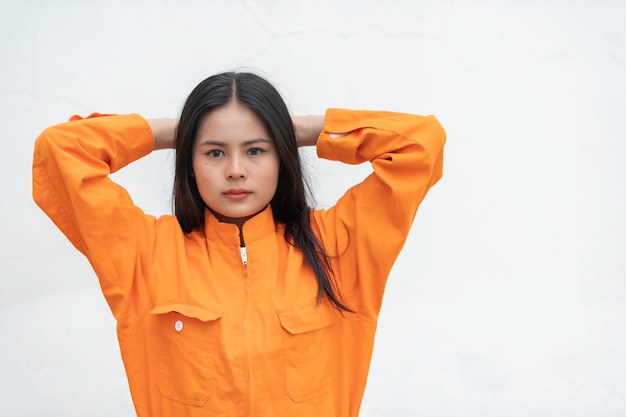 Prisoner in orange robe conceptPortrait of asian woman in Prison uniforms on white background