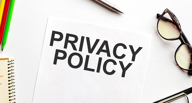 Photo privacy policy on paper sheet with glasses and pencils