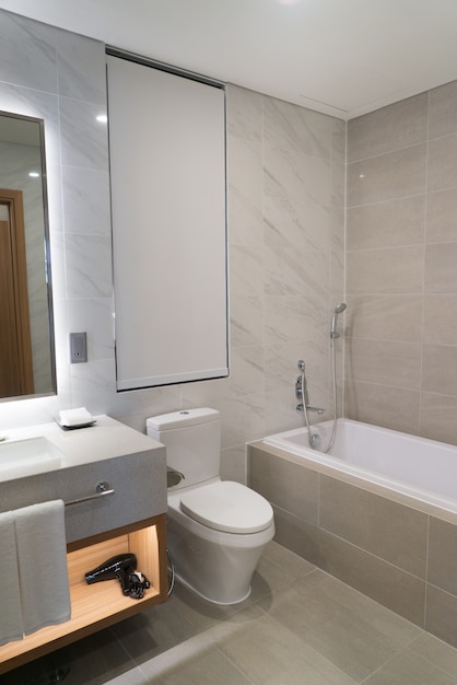 Private bathroom with toilet and bath in hotel. 