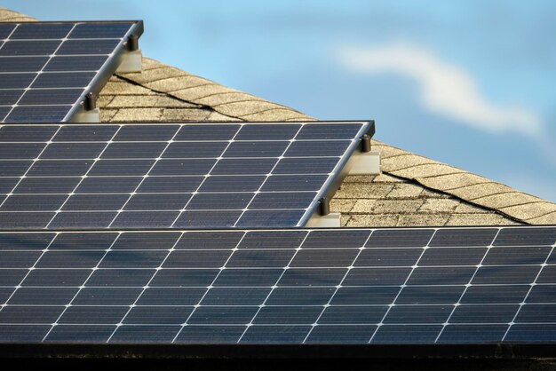 Privé huisdak bedekt met fotovoltaïsche zonnepanelen voor het opwekken van schone ecologische elektrische energie in een landelijk stadsgebied in de buitenwijken Concept van autonoom huis