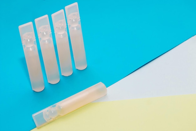 Probiotics medicine in vial on blue background