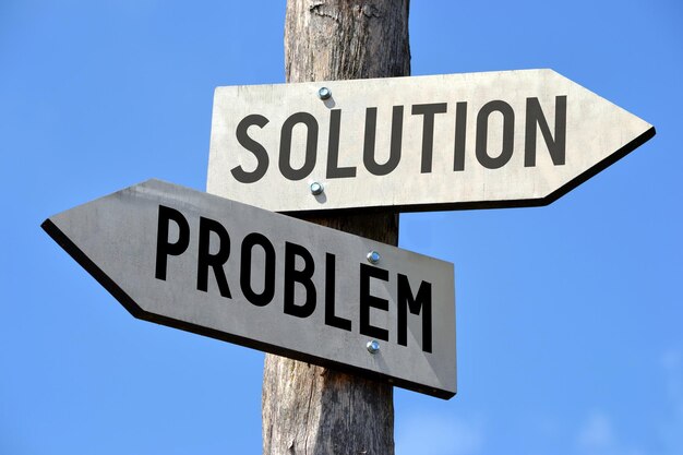 Problem and solution wooden signpost with two arrows