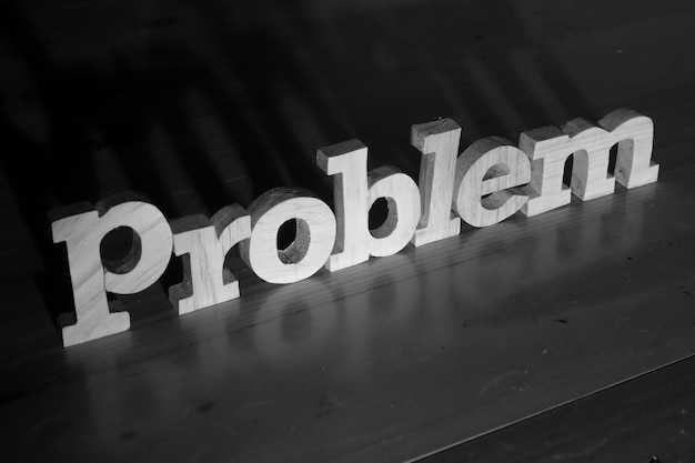 Photo problem text words typography written with wooden letter on black background