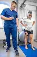 Photo the procedure of myostimulation on the legs of a woman