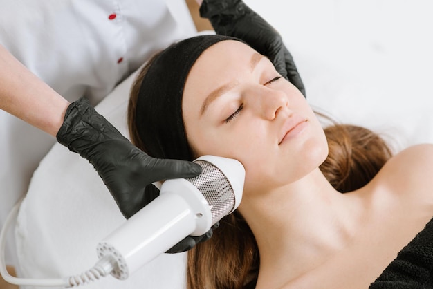 Procedure of ultrasonic cleaning of face in beauty salon.Modern Ultrasonic skin equipment