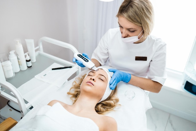 Procedure of ultrasound cleaning of womans face