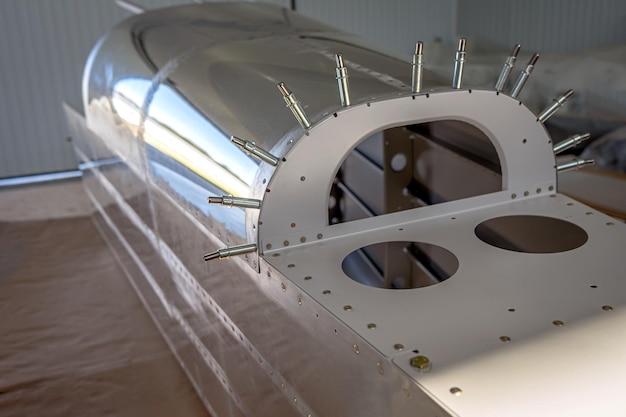 The process of assembling a small private aircraft in the workshop.