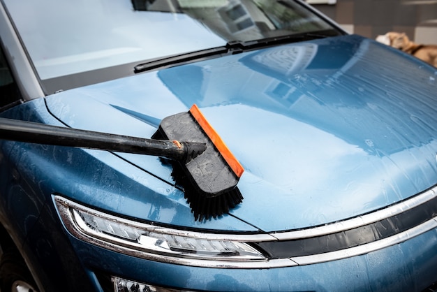 Process of car washing with foam brush.