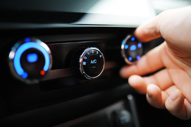The process of choosing climate control in the car Various controls in auto switches Modern car interior