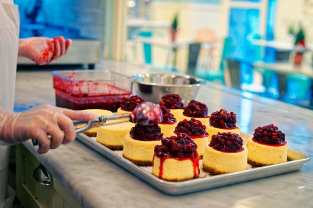 Process of cooking of cheesecake with red berries in the bakery