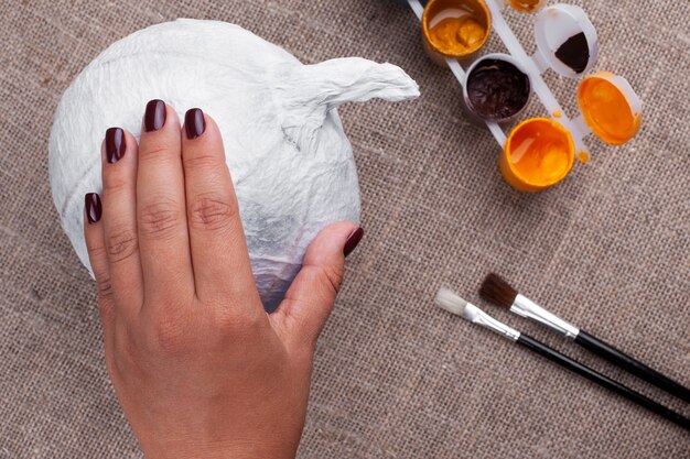 The process of creating pumpkins out of paper mache for Halloween, a holiday in isolation.