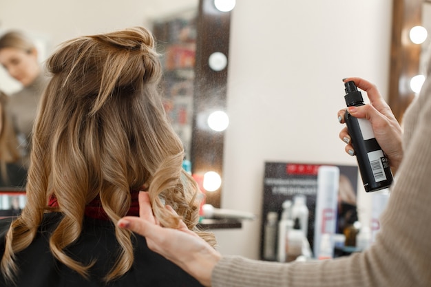 Photo the process of cutting and styling women hair in the salon