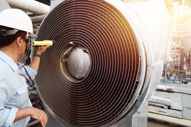 Process engineer inspecting machine