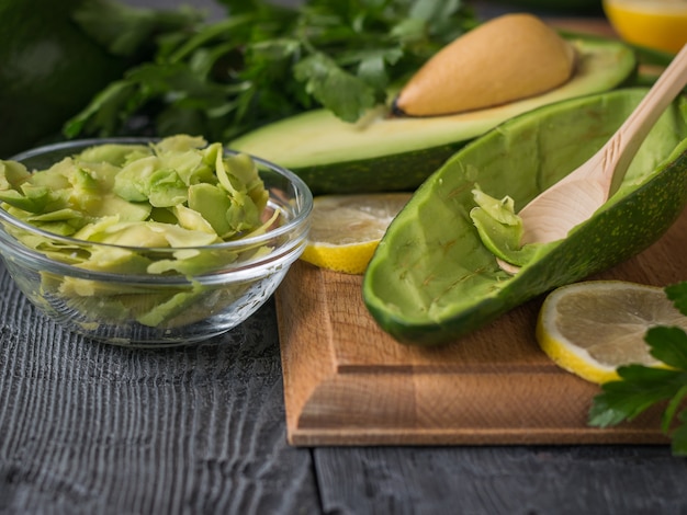 The process of extracting pulp from the fruit of a ripe avocado.