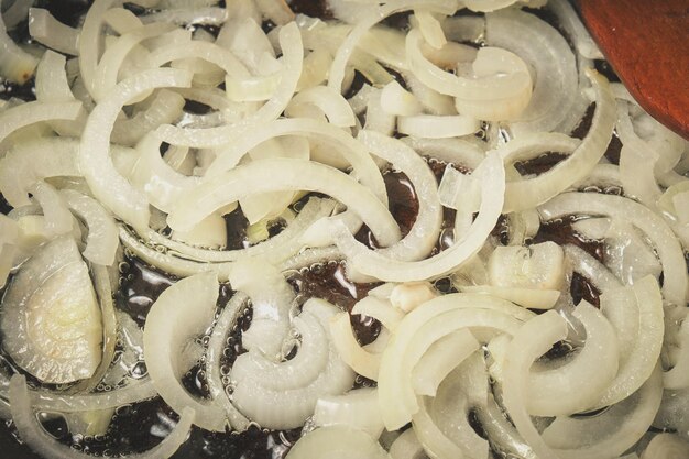 The process of frying onions in a pan