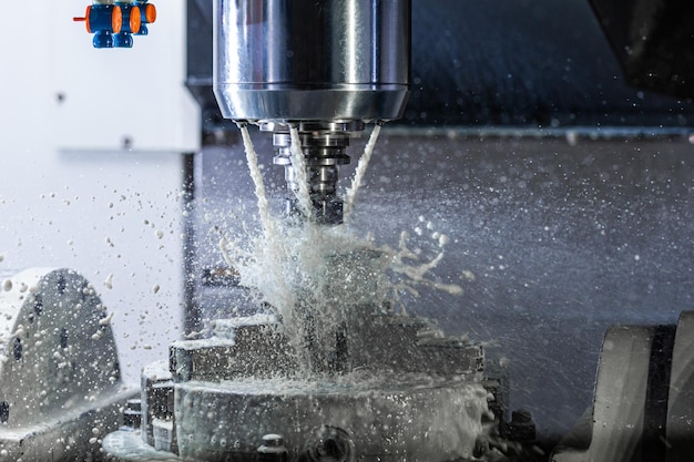 A process of industrial wet milling in 5axis cnc machine with\
coolant flow under pressure and freezed splashes