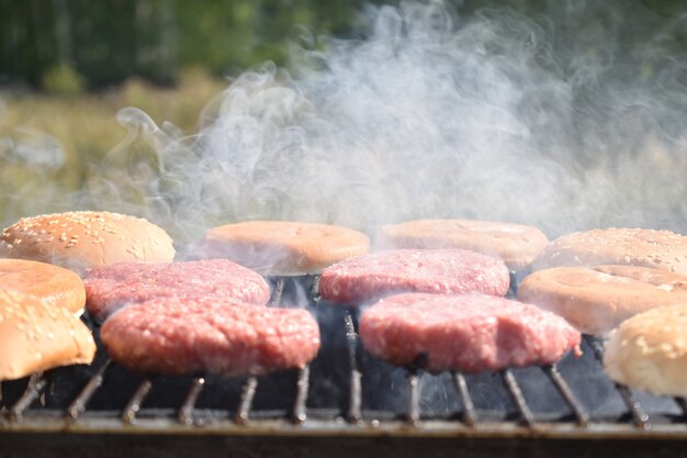 The process of making burgers on the grill in the garden