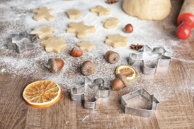 Process of making Christmas cookies on wooden background