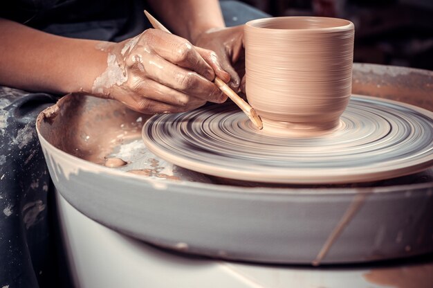 The process of making a clay jug on a potter's wheel. Close-up.