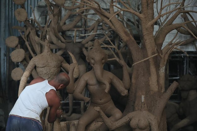 process of making ganesh ji.. selective focus, shallow depth of field, blur  , follow focus