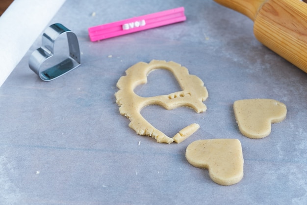 Photo process of making heart-shaped cookies. concept of romantic pastries.