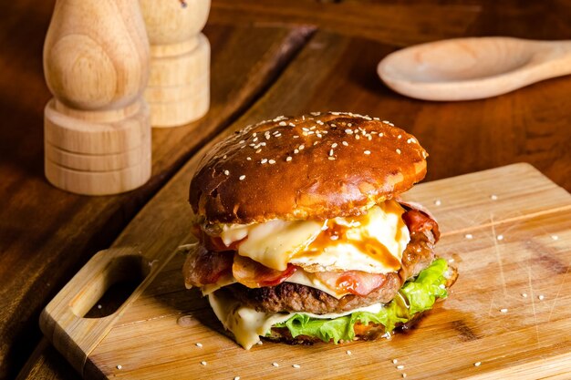 The process of making juicy fresh sesame burgers with beef, meat, cheese, tomatoes, sauce, pineapple