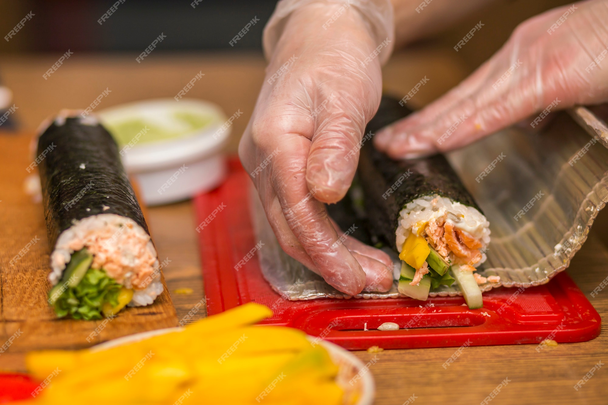 https://img.freepik.com/premium-photo/process-making-sushi-rolls-close-up-man-chef-hands-preparing-traditional-japanese-food-home-restaurant-kitchen-table_127089-7030.jpg?w=2000