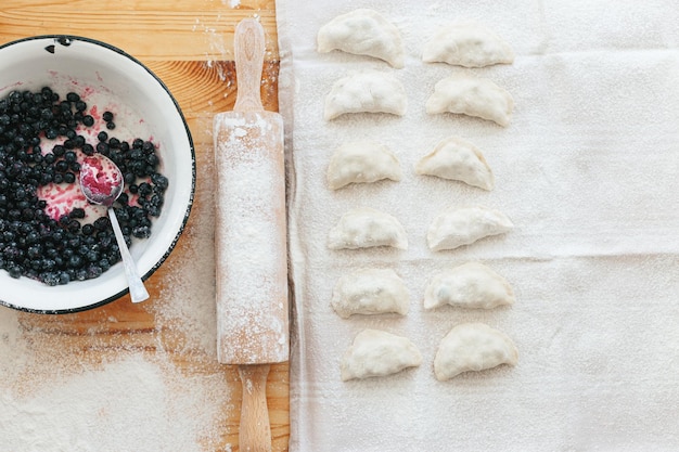 Process of making sweet varenyky vareniki pierogi with berries traditional ukrainian food