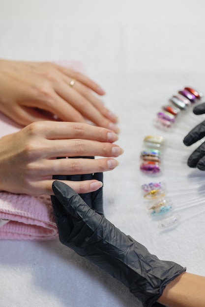 The process of manicure in a studio or beauty salon for women a\
manicure and pedicure master makes